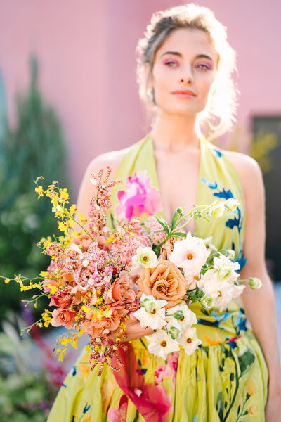 bride holding colorful bouquet