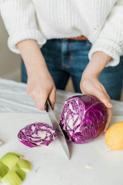 nutrition coaching woman cutting a cabbage