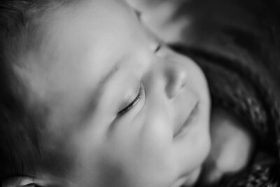 A serene black and white image of a peacefully sleeping baby, capturing innocence and tranquility.
