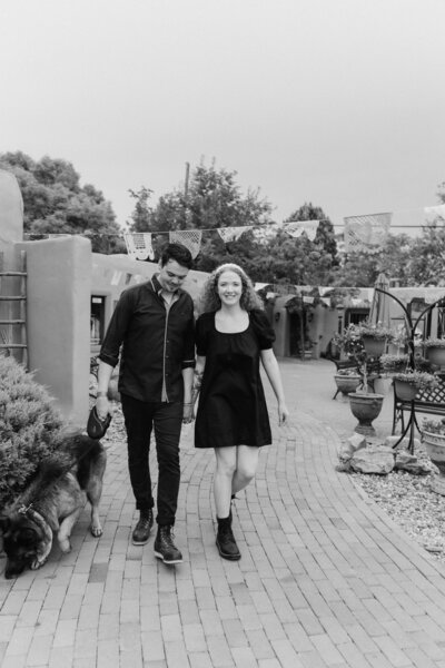 a couple walking in old town together with their dog