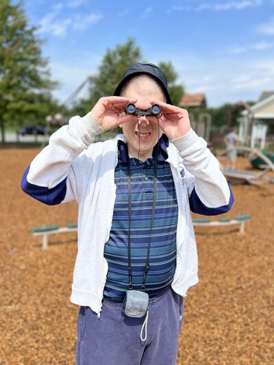 Image of solid rock friend looking through binoculars.