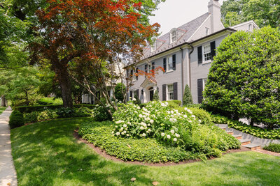 Old home with beautiful lush landscaping