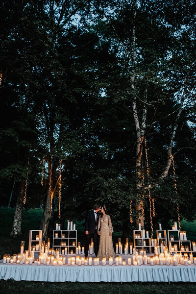 couple standing around candles