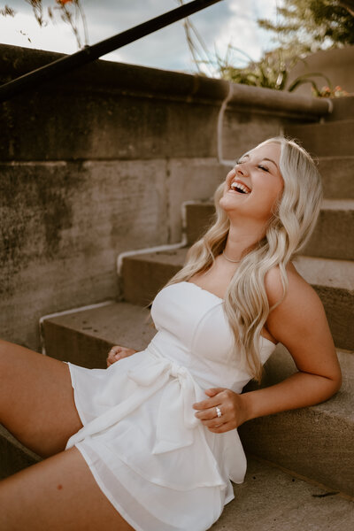 A photo of a girl laughing during her senior photos in Bloomington, Indiana.