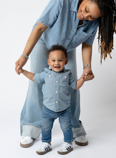 Mom standing up and walking with baby boy. Photographed at Atlanta photo studio by Jenni Nikki Photography.