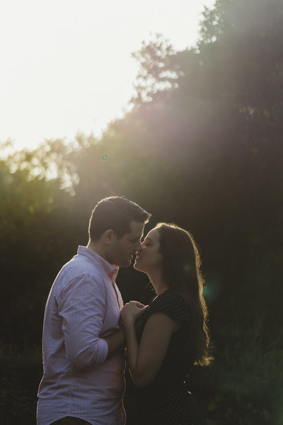 a young couple kiss in central park