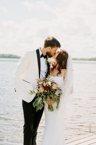 Bride and Groom first look on lake shore dock