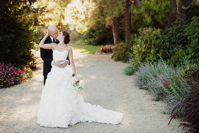 Bride and Groom on Path at Maravilla Gardens Kissing