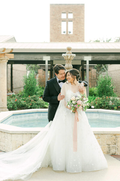 Houston wedding photos of couple by fountain