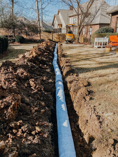 drainage-pipe-in-trench-going-through-backyard