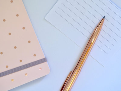 Pink journal gold pen flat lay