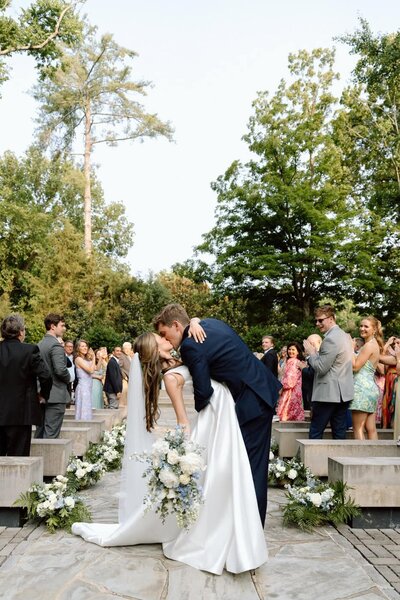 couple kissing at the end of the aisle at belle meade historic site and winery in nashville