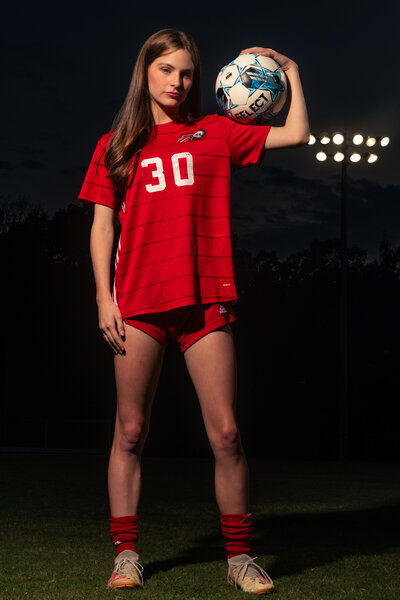 Senior Girl Soccer Player Holding Ball