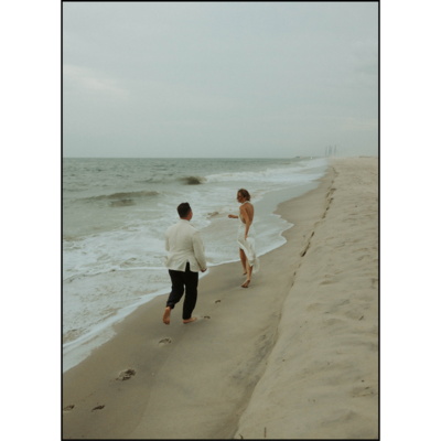 Joyful couple running on the beach after a destination wedding in Delaware
