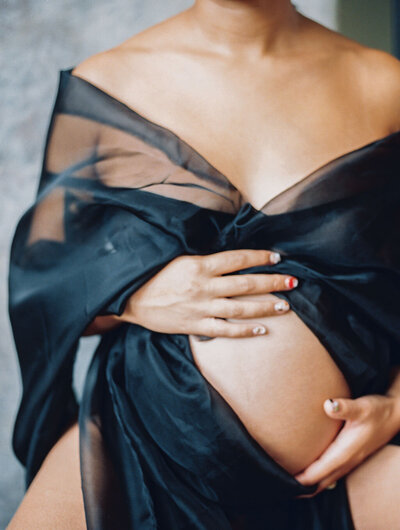RIchmond maternity photographer | Film photo of a mother wrapped in black tuille with her pregnant belly exposed by Jacqueline Aimee Portraits