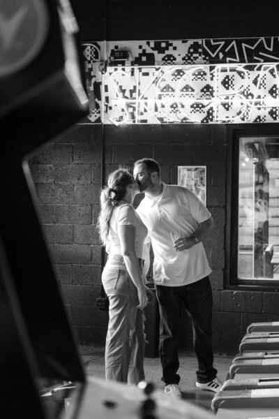 black and white image of couple at an arcade