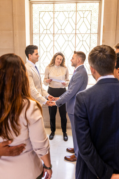 two grooms exchange vows at san francisco city hall