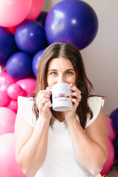 brand photo of a life coach posing in her desk with favorite books