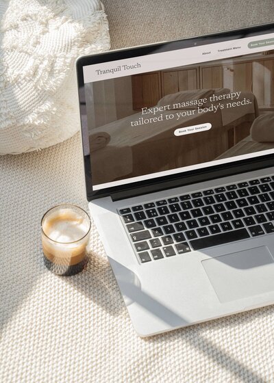  A laptop placed on a table in a cozy bedroom setting, showcasing a modern and inviting atmosphere.