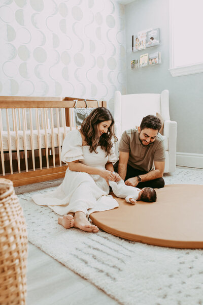 couple-looking-at-newborn-in-house