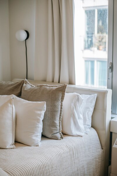 Comfy couch with lined linen pillows - West Village Realty