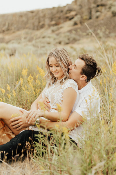 couple holding each other in a flower field