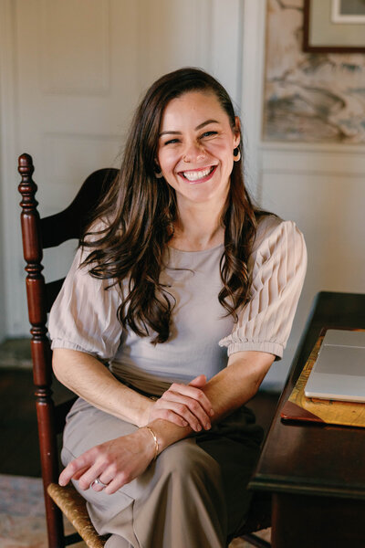 Richmond, VA wedding photographer working at her laptop, editing beautiful wedding photos and providing personalized photography services to couples