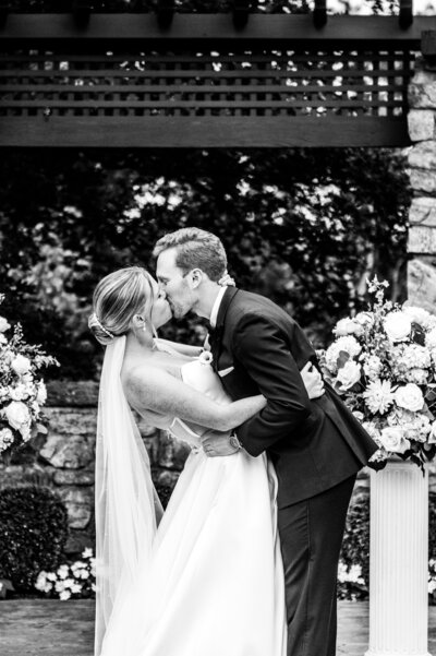 Bride and Groom at wedding kissing outside after getting married