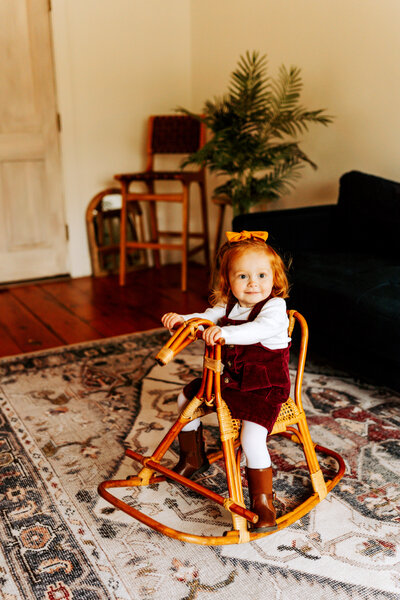 little girl on rocking horse at Dollhouse Studio in Taylors Falls Minnesota