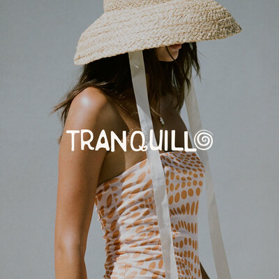 Woman in hat with logo on top