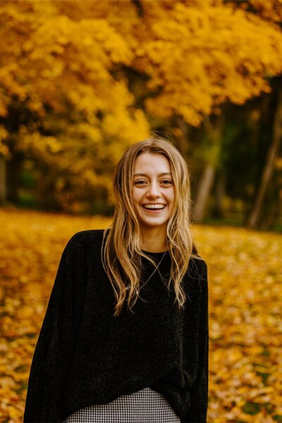 Roxy smiles during her fall senior photography session in Bozeman.