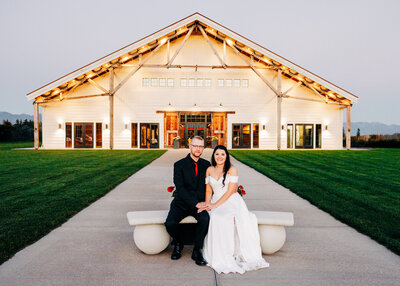 Bride and groom sitting in front of Snowline Acres in Kalispell, MT