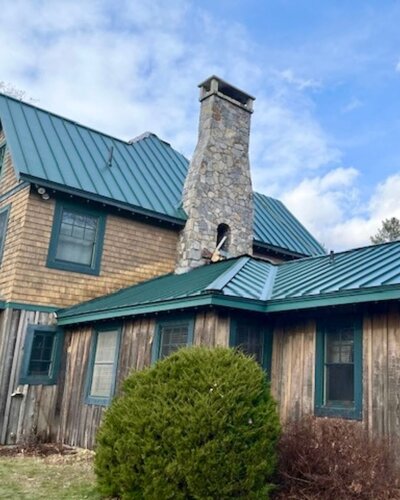 Building with new green metal roofing