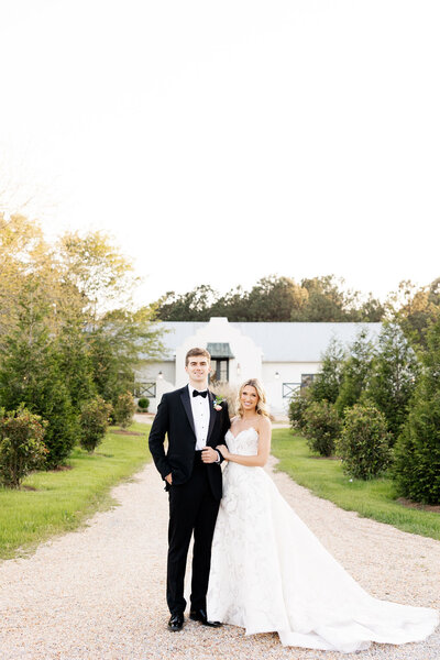 Bride and groom smiling outside wedding venue — Madison Abernathy Photo