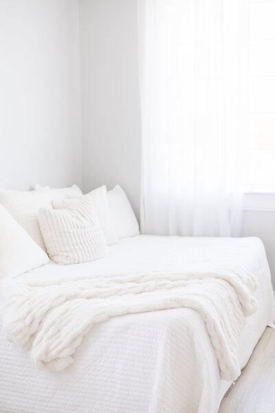 Portrait of a white bed in a bright and neutral northern kentucky photographer studio