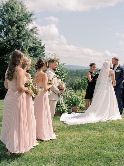 Bridesmaids standing during the ceremony
