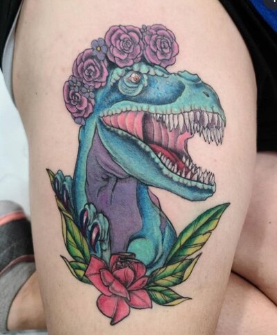 Tattoo of colorful dinosaur wearing a floral crown