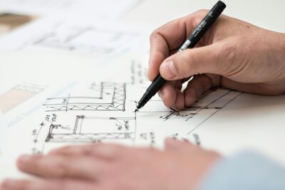 Interior designer sketches out multiple layout options for their client