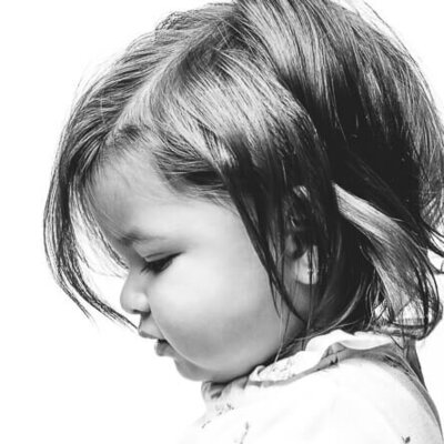 Monochrome image of a little girl with dark hair