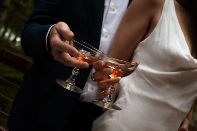 Bride and groom share a glass of wine before their intimate wedding dinner in Seattle, Washington
