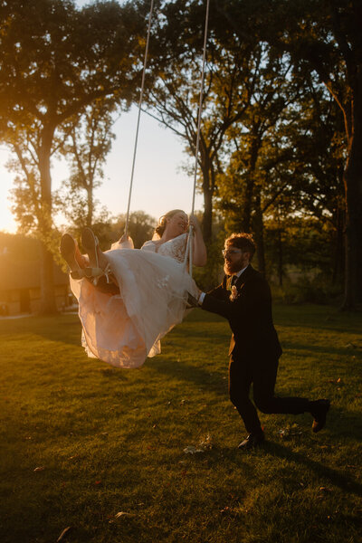 bride and groom holding hands around a corner