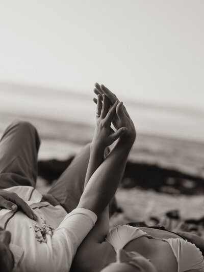 destination elopement photography  in hawaii bride and groom laying while eloping on the beach