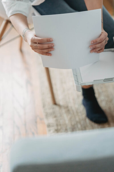 Woman in office clothing shuffling papers
