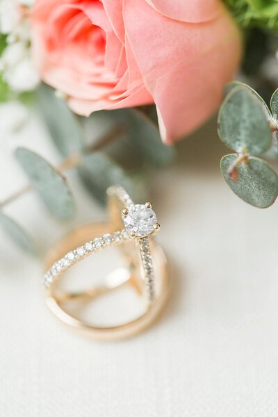 Pink flowers and wedding rings