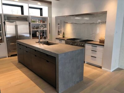 Concrete countertop with waterfall edges on island with integrated sink