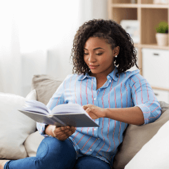 Black woman relaxing reading a book