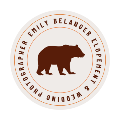 white colored circle badge with a maroon bear on it that says emily belanger photography elopement and wedding photographer