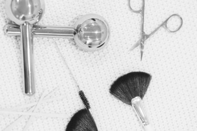 Flat lay of skincare tools laid out on a facial towels