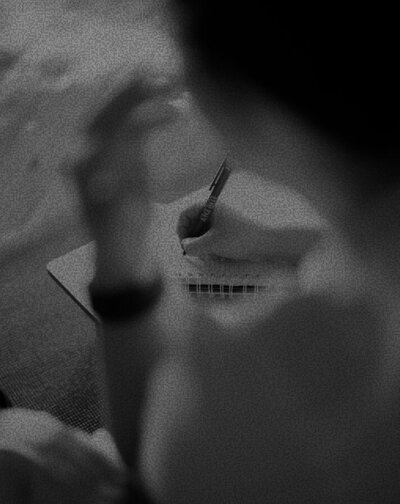 blurred photo of Lois writing on a piece of paper