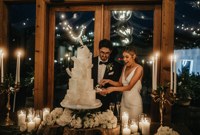 Couple cutting wedding cake